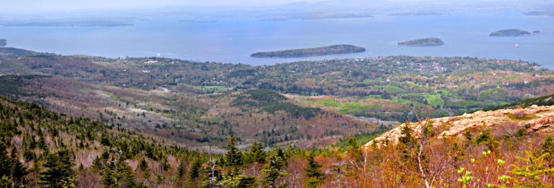 [Bird's eye view (through some haze) of the town and surrounding areas as well as multiple islands in the bay.]